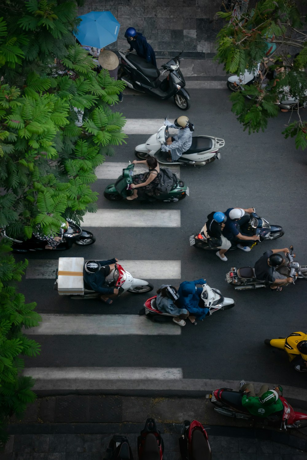 a group of people riding motorcycles down a street