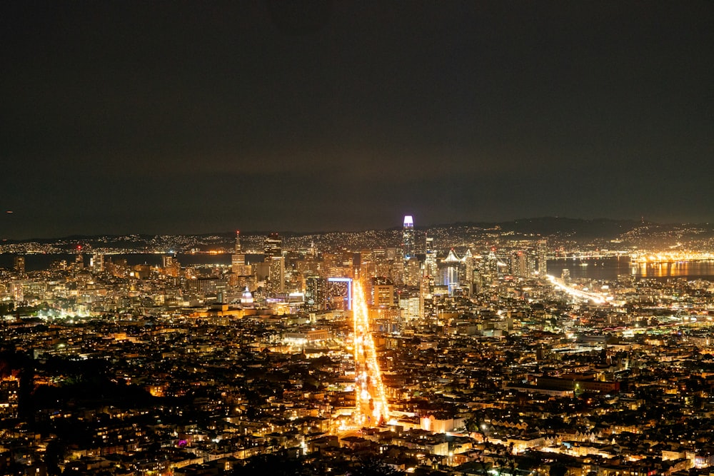 a view of a city at night from the top of a hill