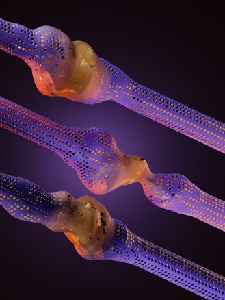 Intricate structures resembling nanofibers or cellular formations are depicted with a blend of purple and gold hues. The surfaces are perforated with numerous small holes, creating an intricate, organic appearance. The background is a smooth gradient of dark purples, enhancing the vibrant colors of the main elements.