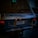 A vintage Range Rover with a Dubai license plate parked in a dimly lit area. The car's back shows the model name 'Vogue SE' and the plate number '22000'.