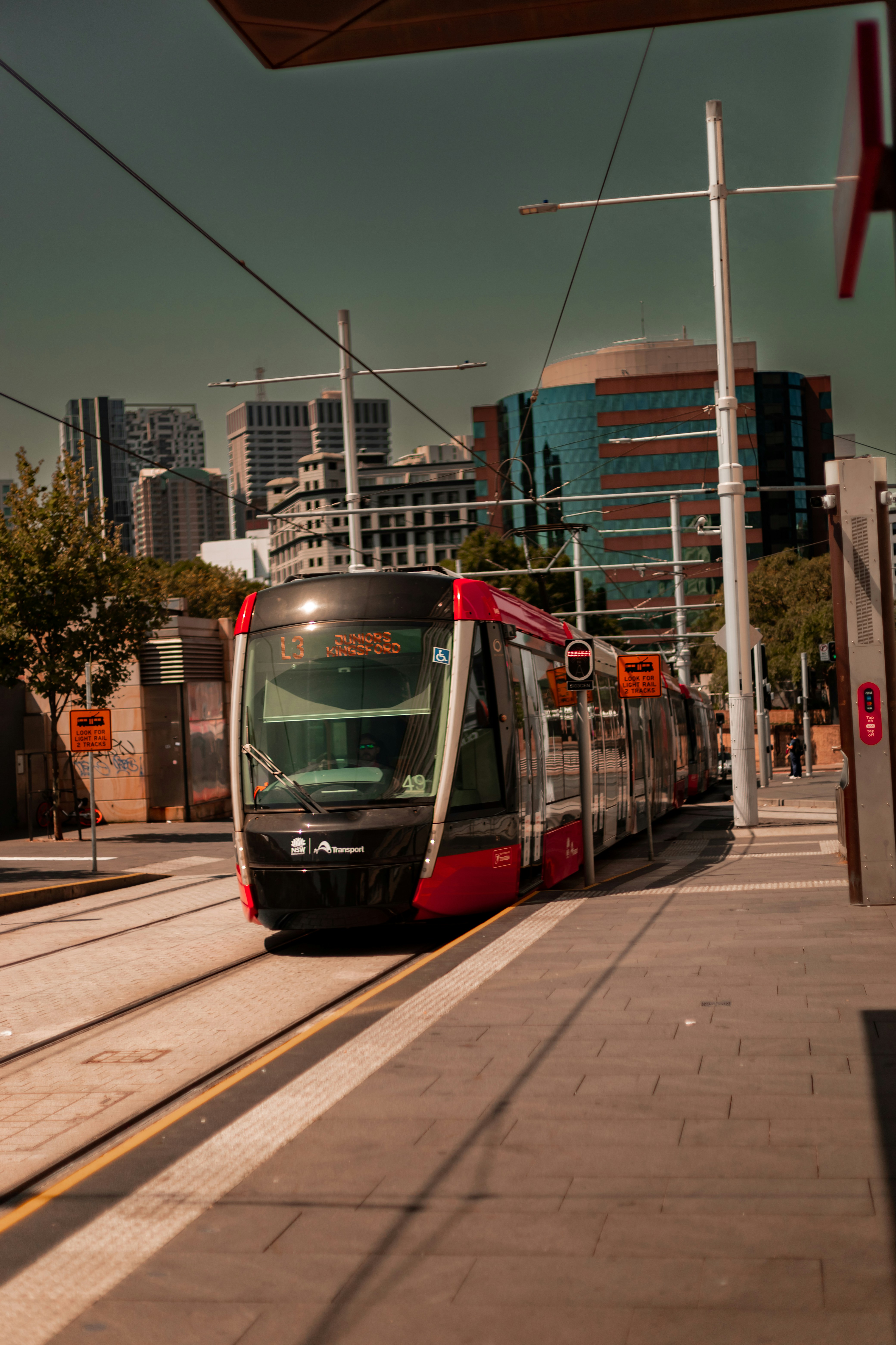 a red and white train traveling down train tracks