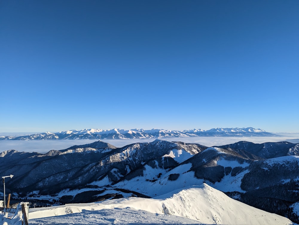 a person standing on top of a snow covered slope