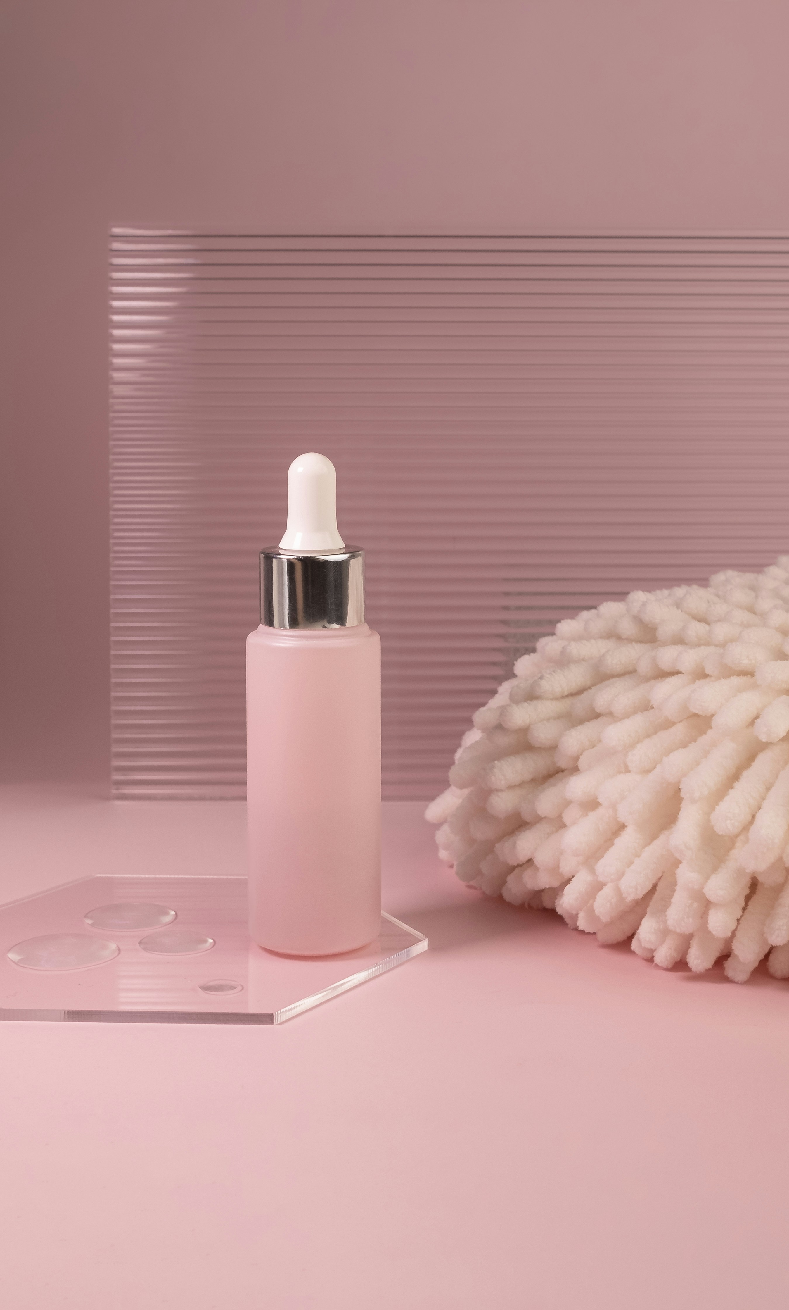 a white mop sitting next to a bottle of liquid