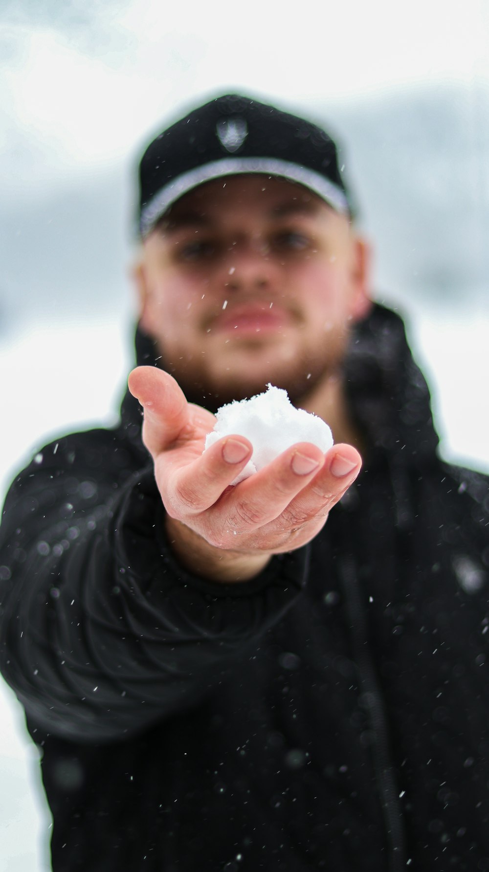 a man holding a snowball in his hand