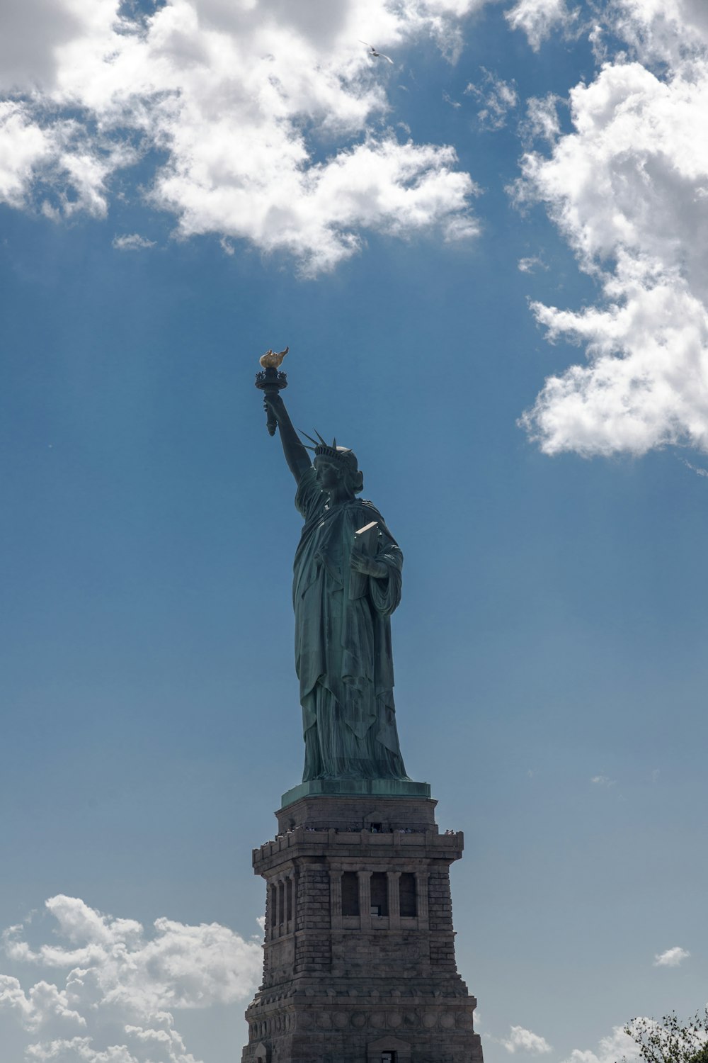 the statue of liberty is shown against a blue sky