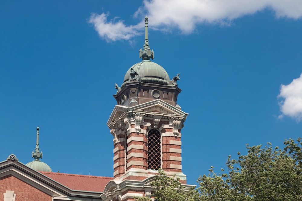 a clock tower on top of a building with a sky background