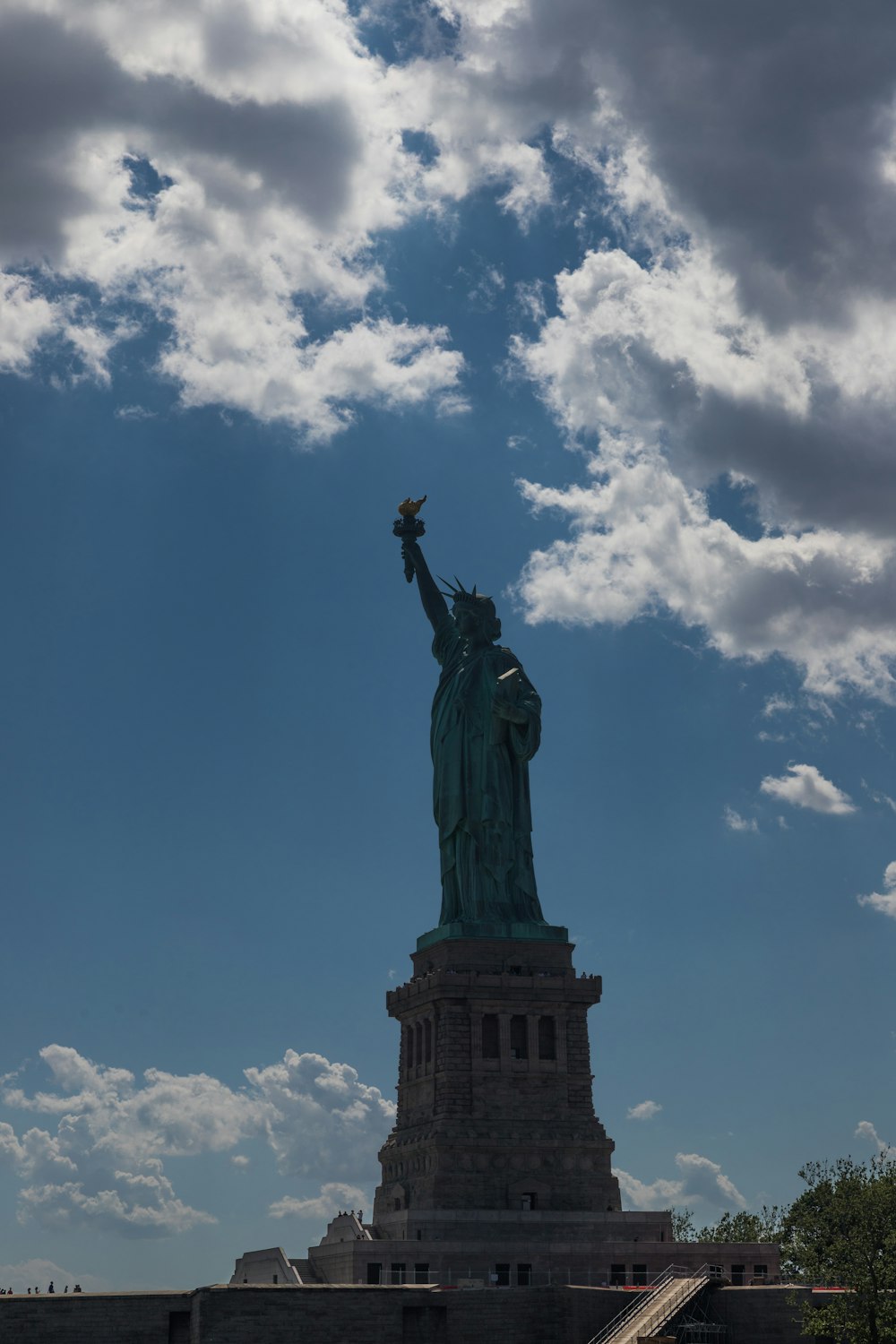 the statue of liberty under a cloudy blue sky