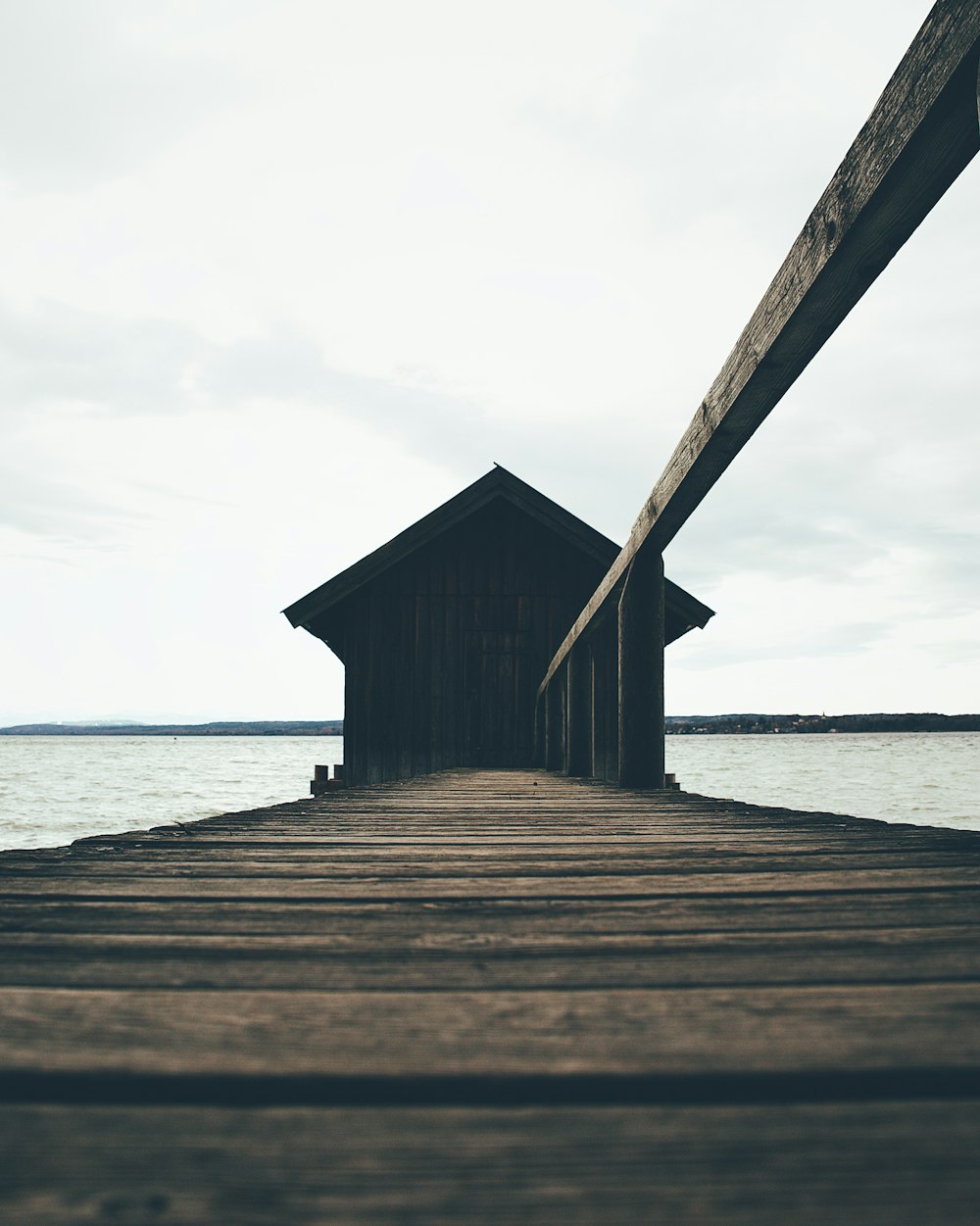 a wooden dock with a house on top of it