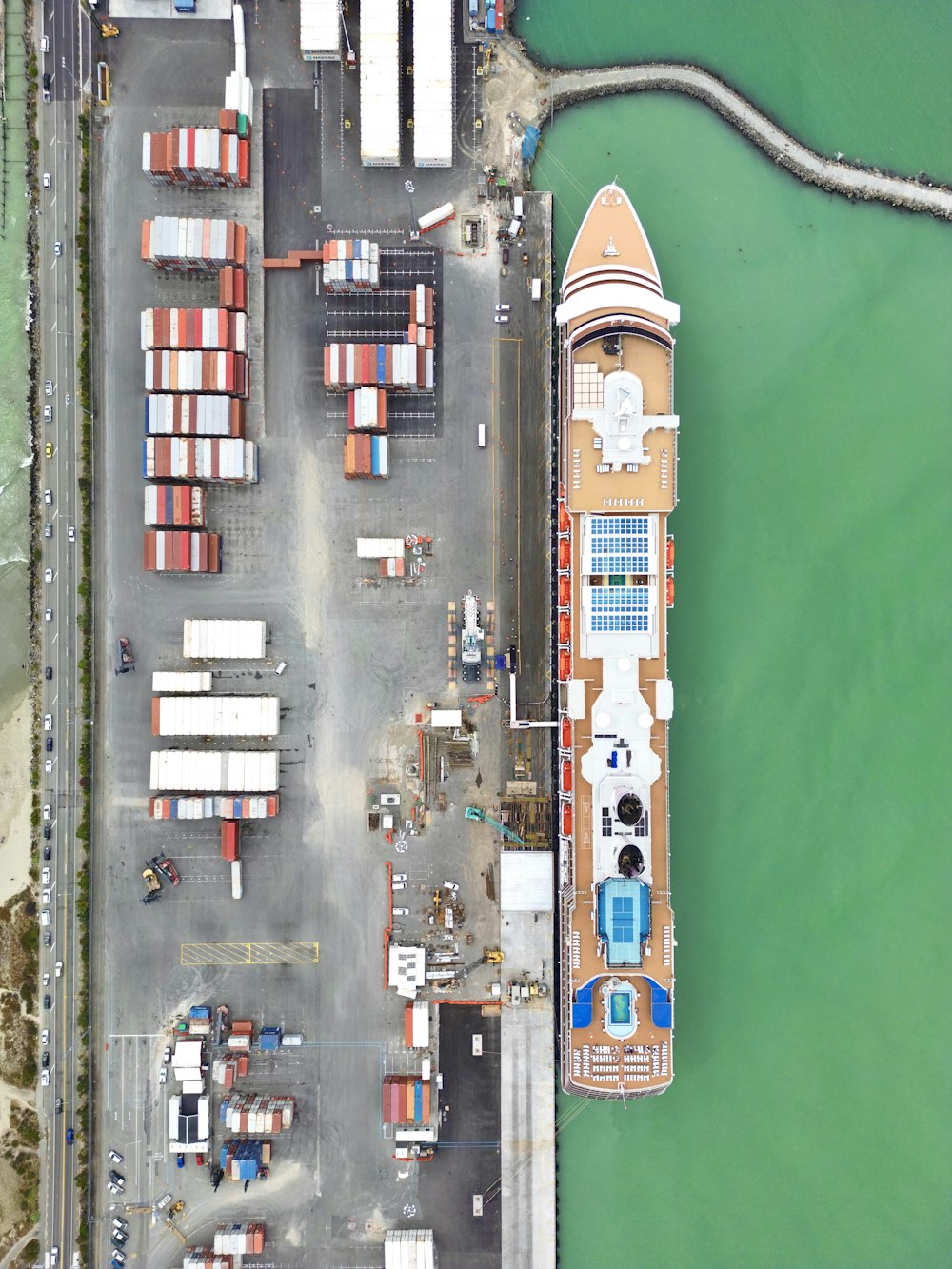 an aerial view of a dock with a large boat in the water