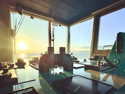 Maritime control room with screens displaying real-time fleet tracking data.