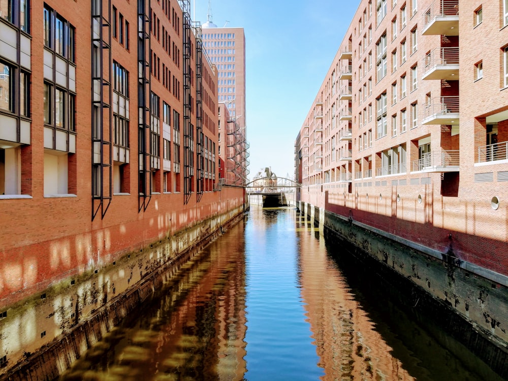 a river running through a city next to tall buildings