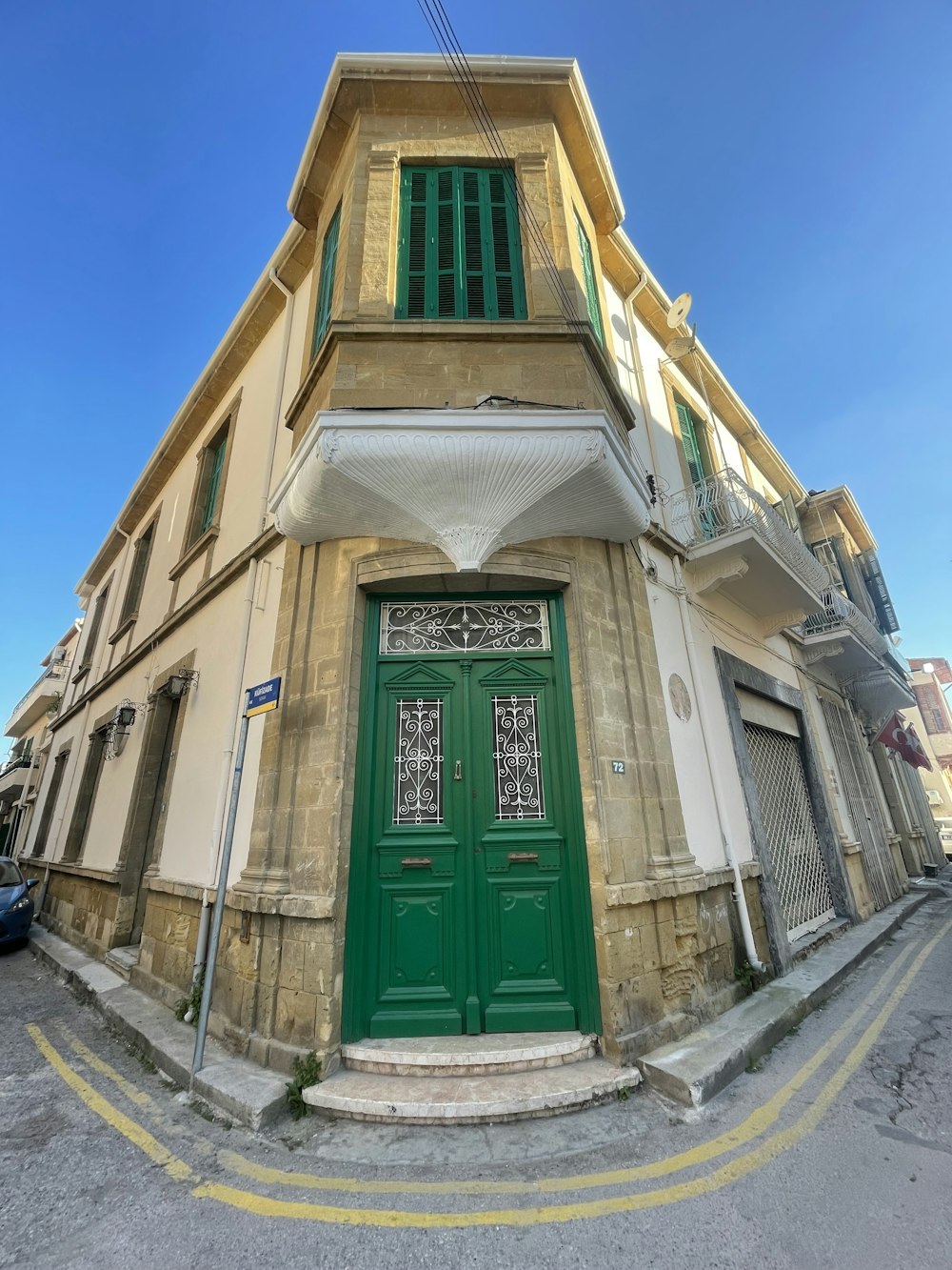 a green door on the side of a building