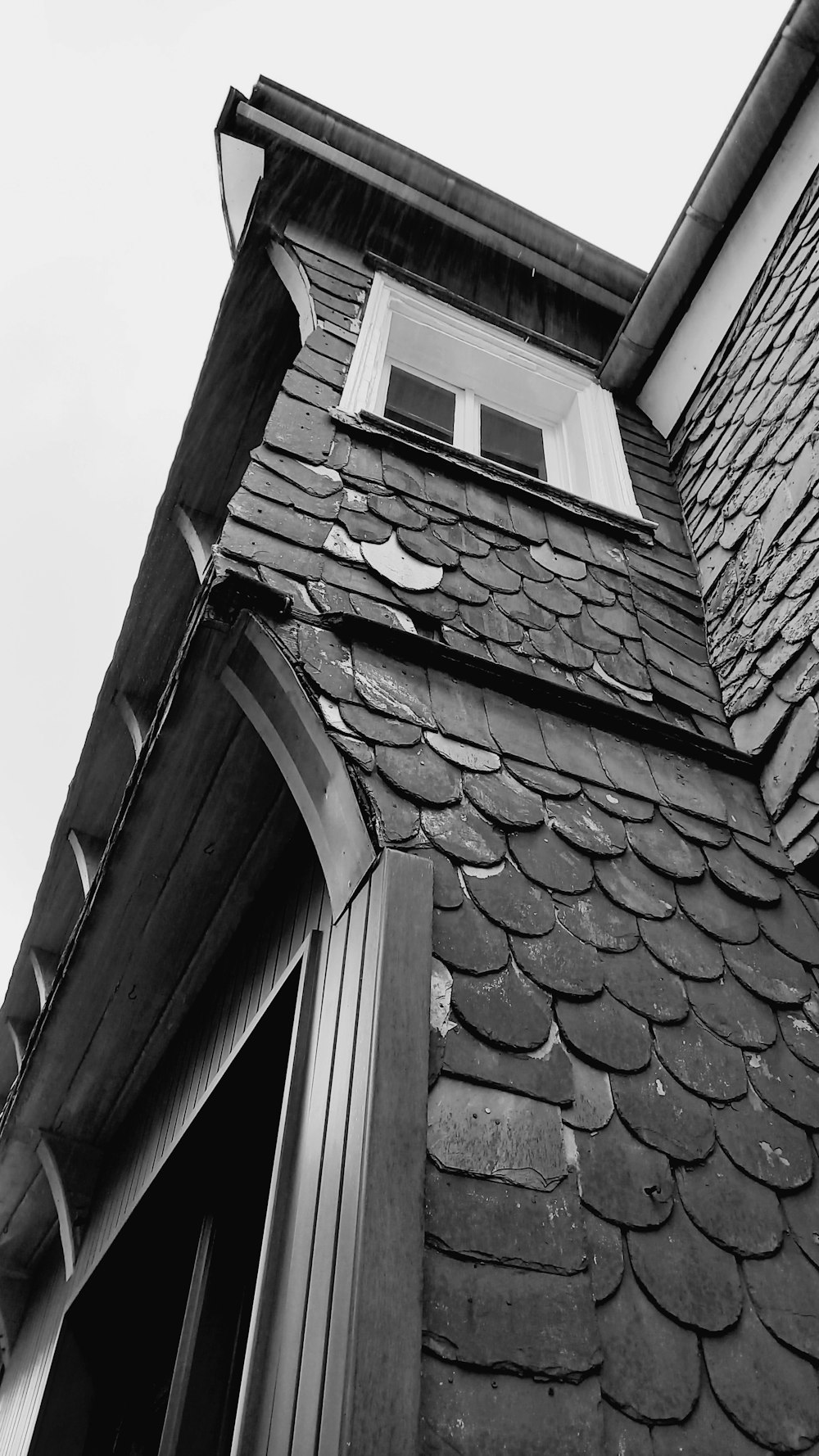 a black and white photo of a building with a window