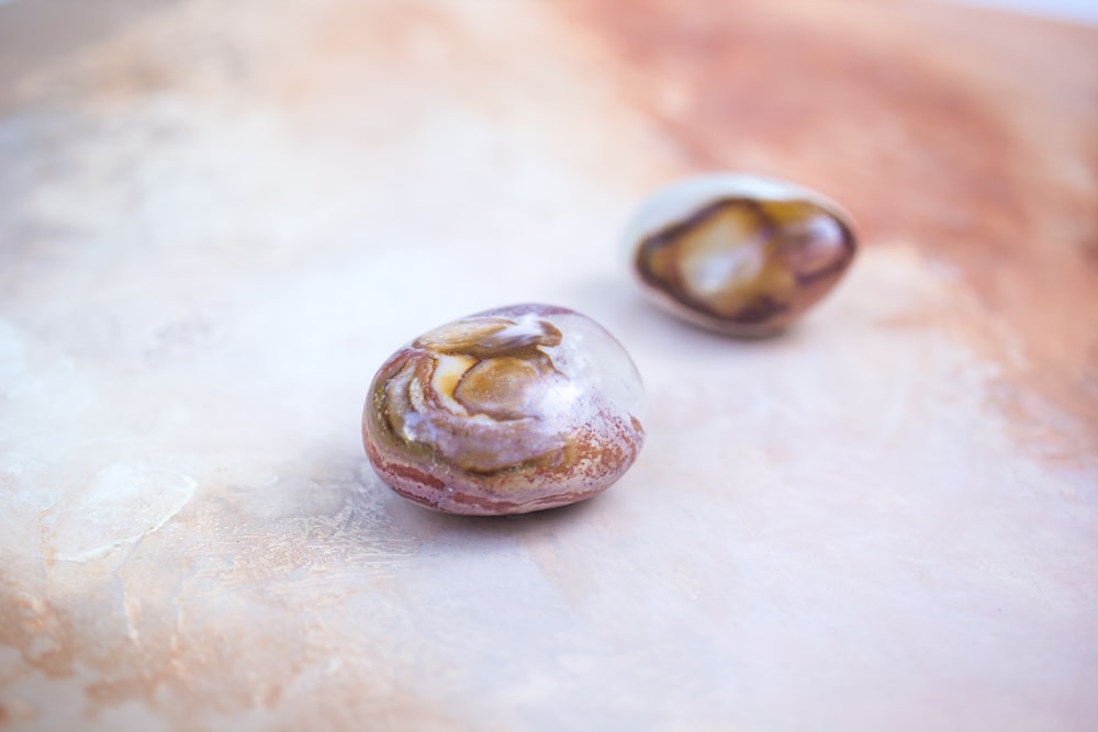 a close up of two fruits on a table