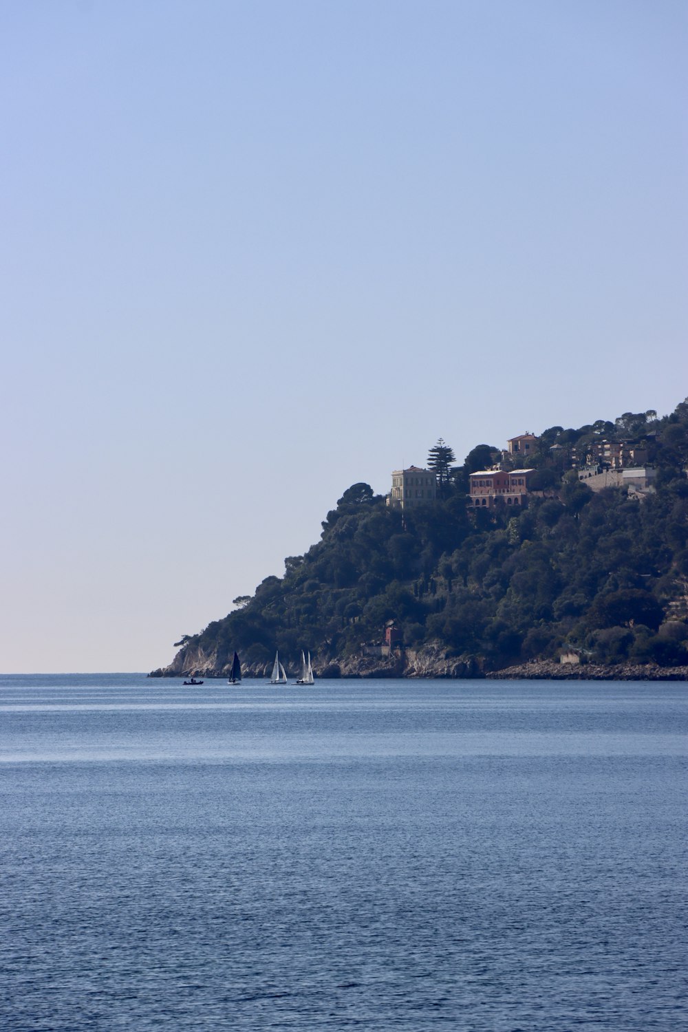 a body of water with a hill in the background