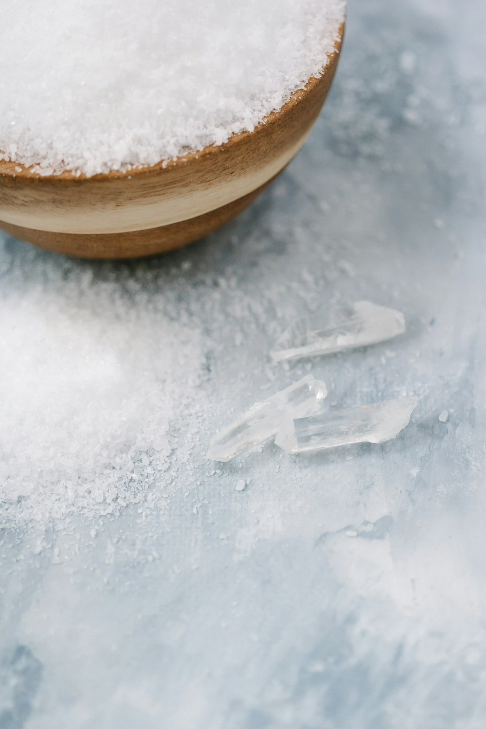 a wooden bowl filled with white powdered sugar