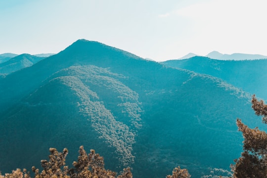 A serene landscape with mountains and a clear blue sky, symbolizing sustainability and knowledge.