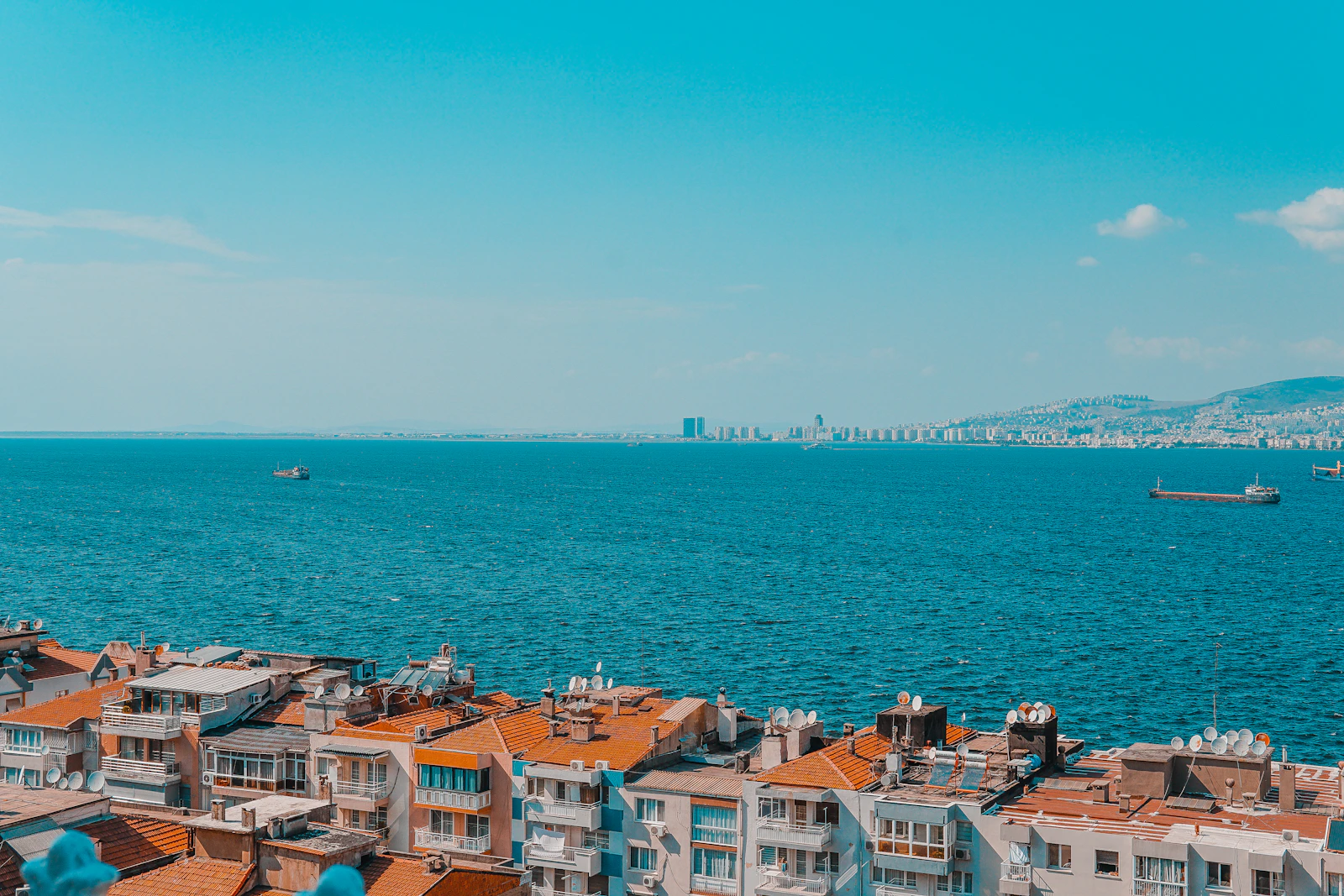 Izmir's waterfront and dense city edge beside blue water
