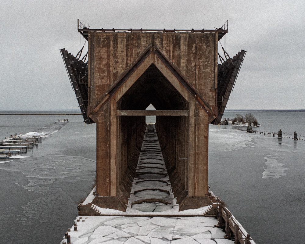 a wooden structure sitting on top of a frozen lake