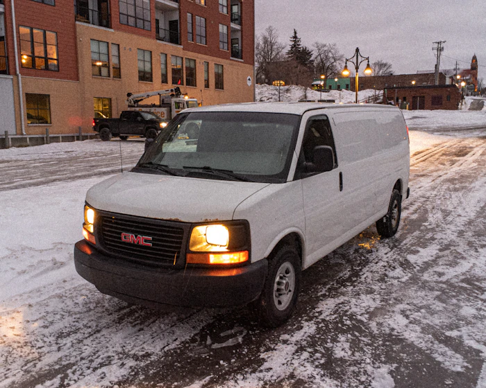A service van parked on a snow-covered street