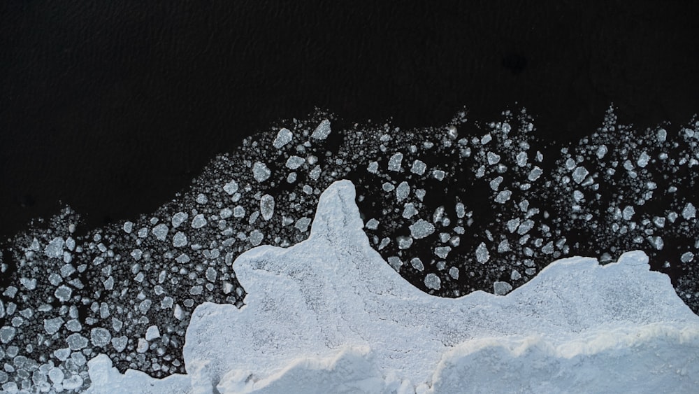 an aerial view of snow and ice on the water