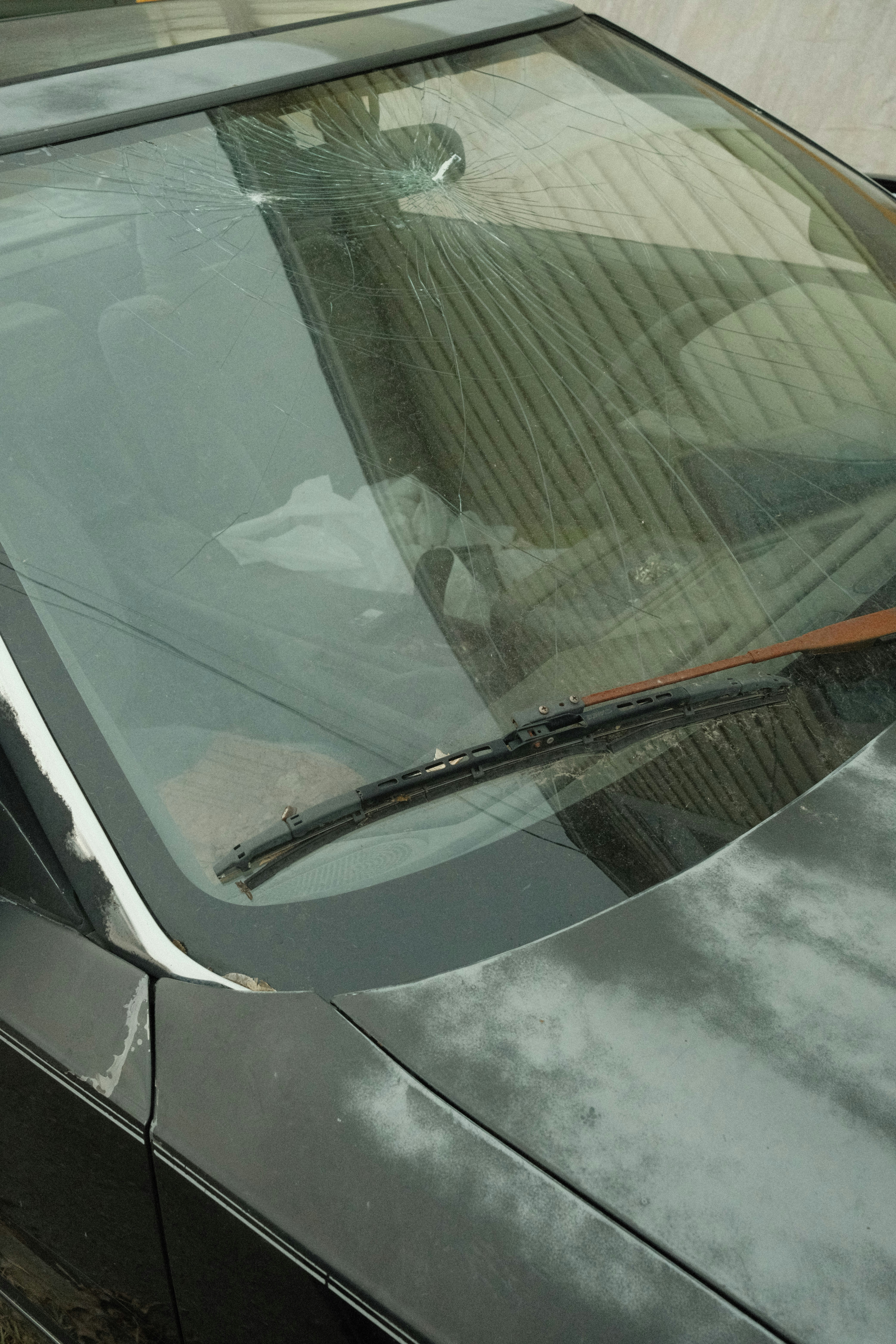 a close up of a car with a broken windshield