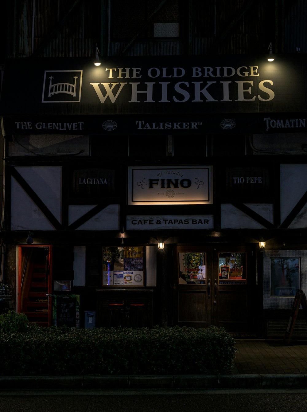 a building with a sign that says the old bridge whiskies