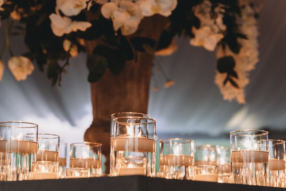 a table topped with lots of glasses filled with water