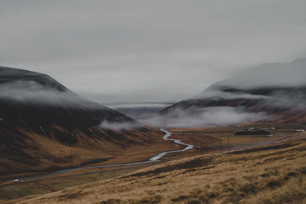 a scenic view of a valley with a river running through it