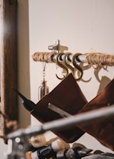 Close-up of Tuuchi’s self-adhesive screw hooks holding kitchen utensils against a deep blue galaxy-themed wall.
