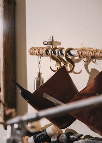 Close-up of Tuuchi’s self-adhesive screw hooks holding kitchen utensils against a deep blue galaxy-themed wall.