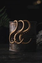 A giant squid monster rising from dark ocean waves, tentacles wrapped around treasure chests.