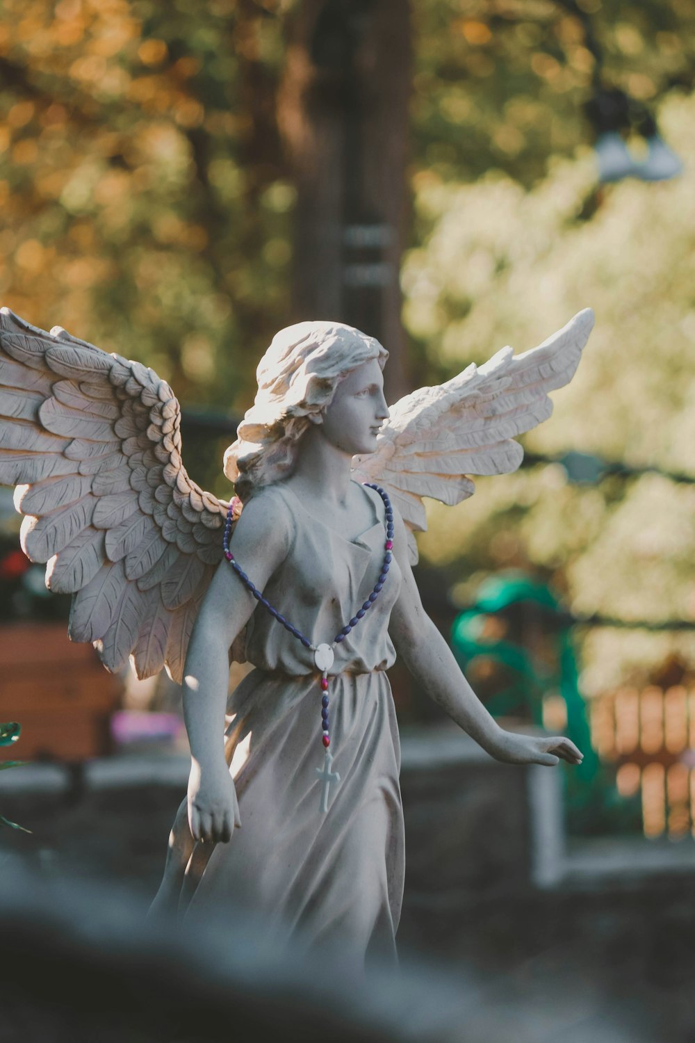 a statue of an angel holding a string