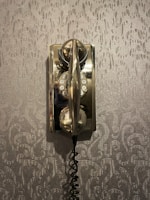 Close-up of a terracotta-toned phone chain draped elegantly over a creamy ivory background.