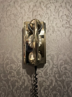 Close-up of a terracotta-toned phone chain draped elegantly over a creamy ivory background.