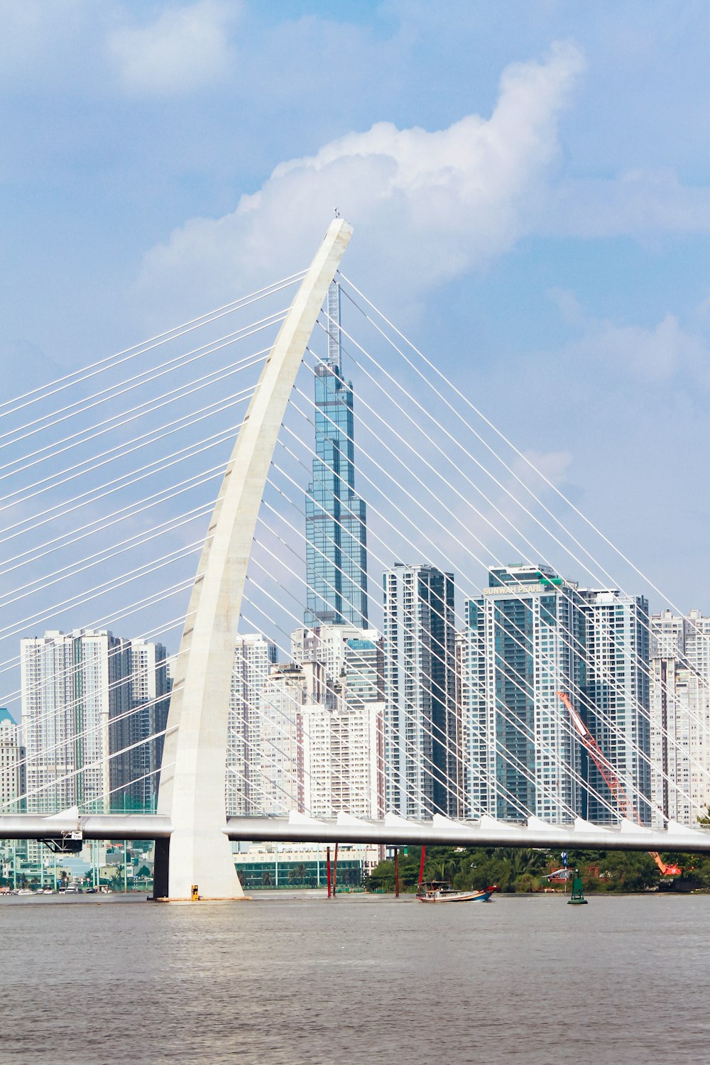 a bridge with a very tall building in the background