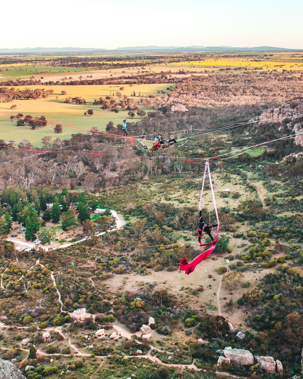 a person on a parachute in the middle of a field