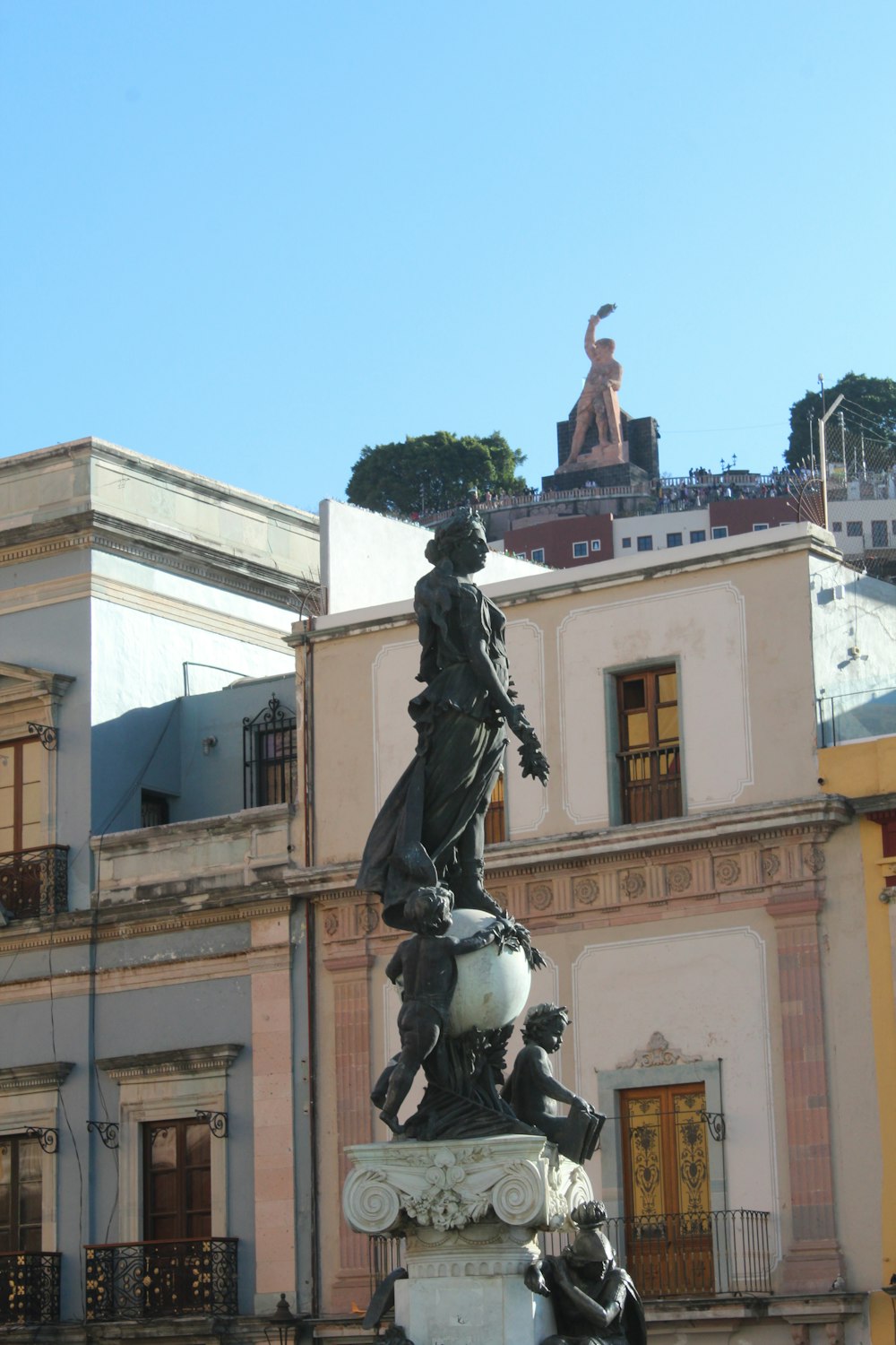 a statue in front of a building in a city