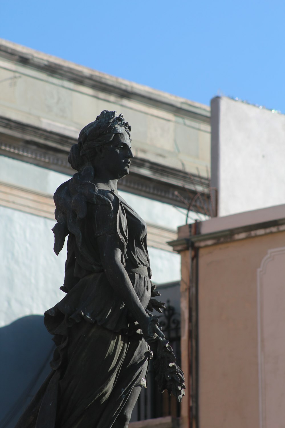 a statue of a woman holding a bird in her hand