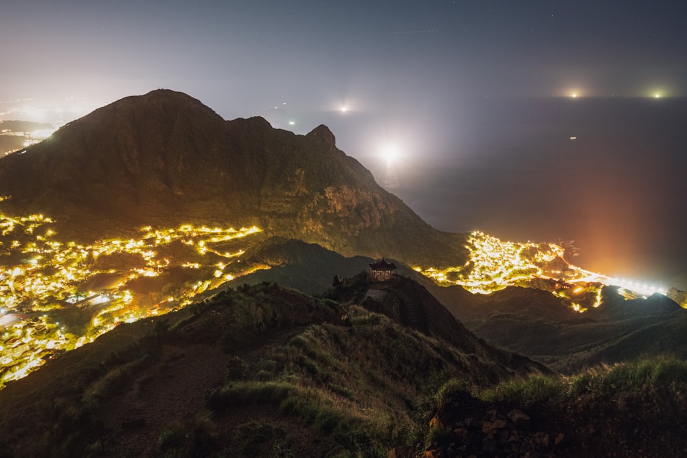 a night view of a mountain with lights on it