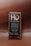 A chocolate bar wrapped in brown packaging with a focus on a square label featuring the brand name Hu and the message 'Get Back to Human.' The product is labeled as Vanilla Crunch Dark Chocolate with 70% organic cacao, vegan, primal, and free from refined sugars, dairy, soy, and other additives.