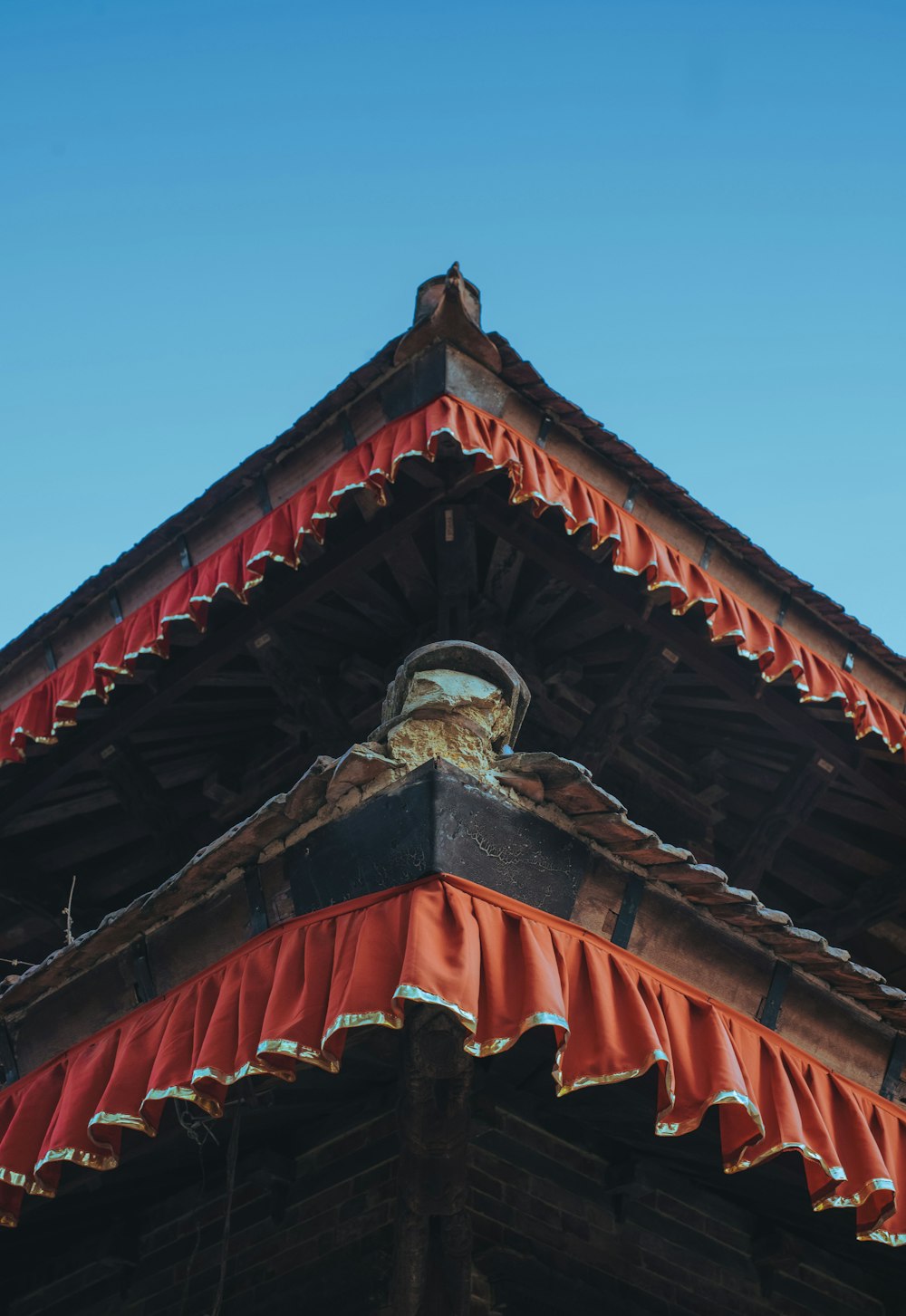 a close up of a roof with a clock on it