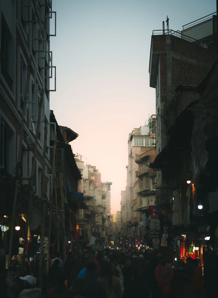 Crowd of people walking down a city street