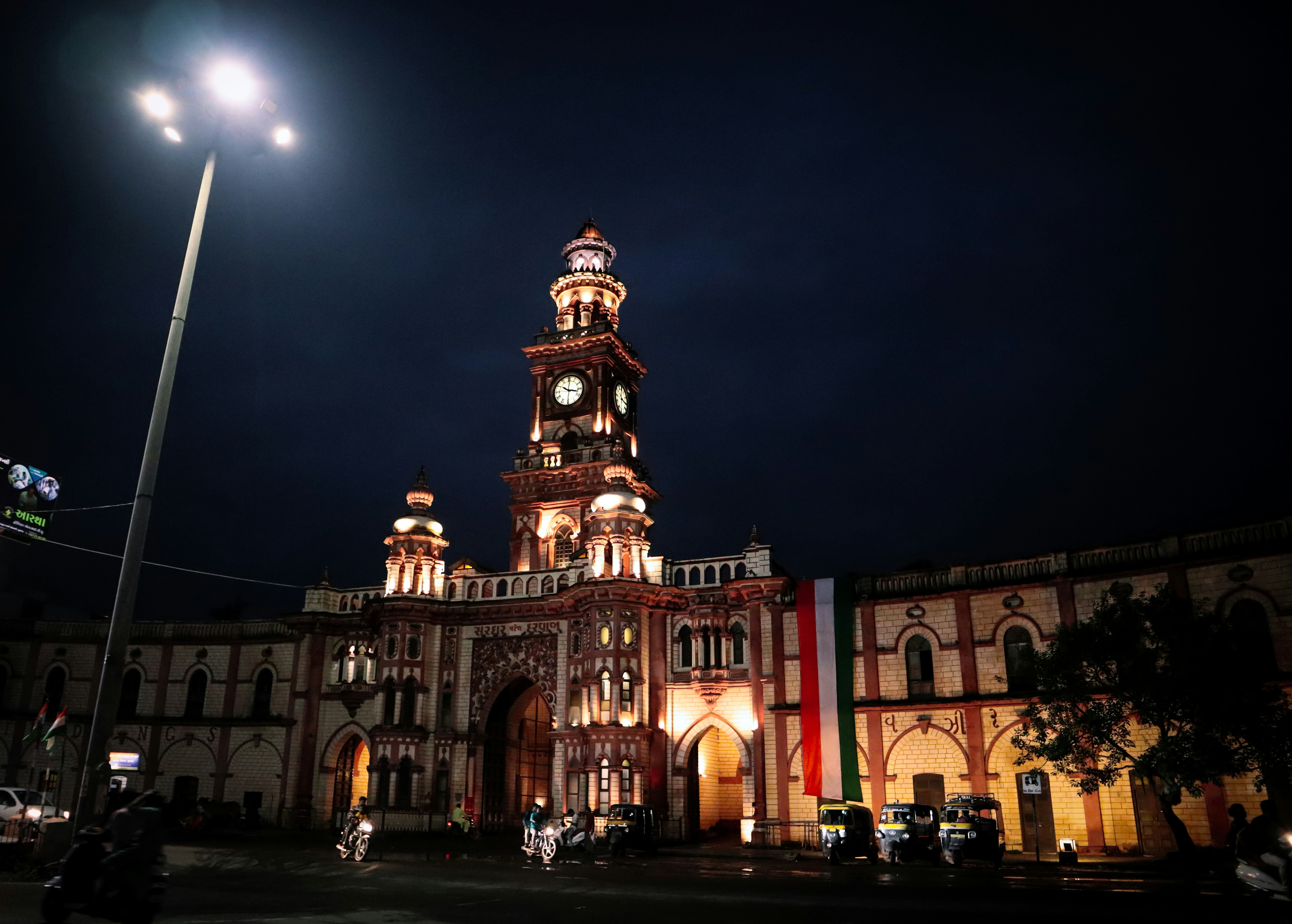 a large building with a clock tower lit up at night