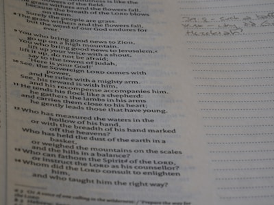 A close-up of a weathered, handwritten note tucked inside an old book.