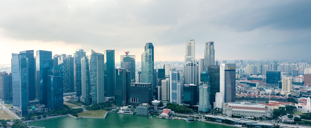 a view of a city with a lake in the foreground