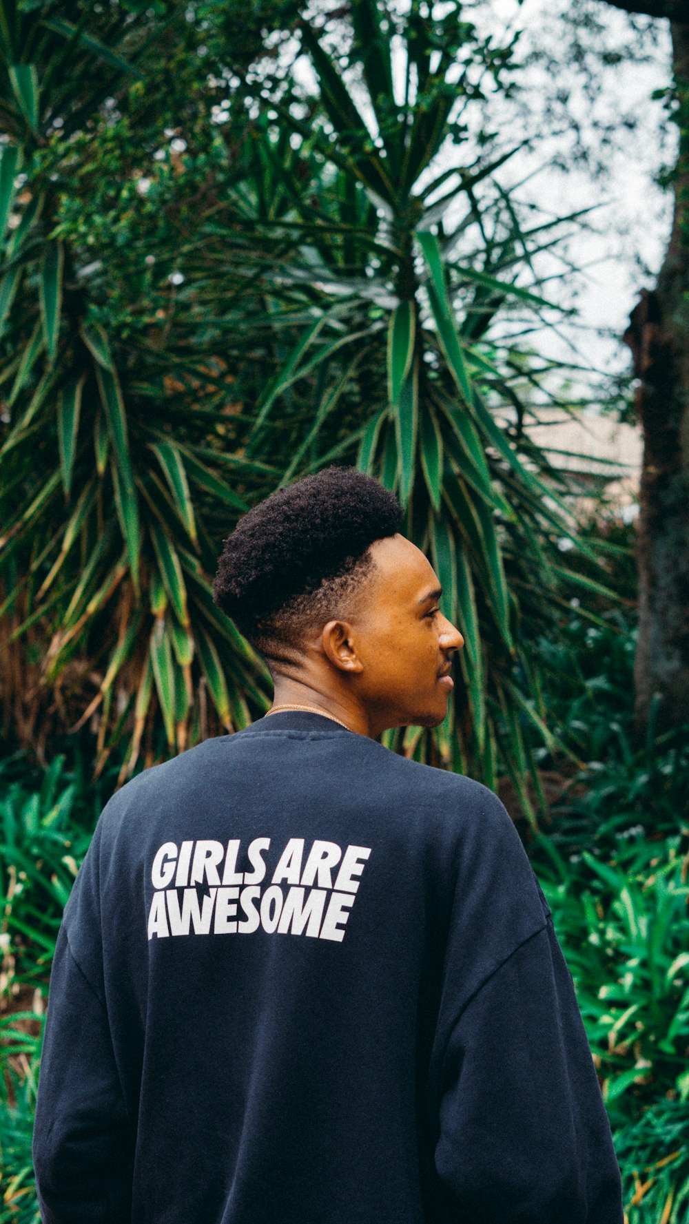 a man wearing a black sweatshirt that says girls are awesome