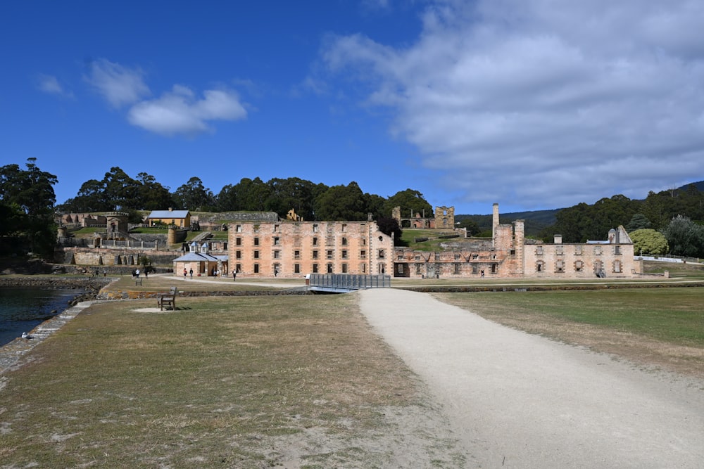 a large building sitting on top of a lush green field