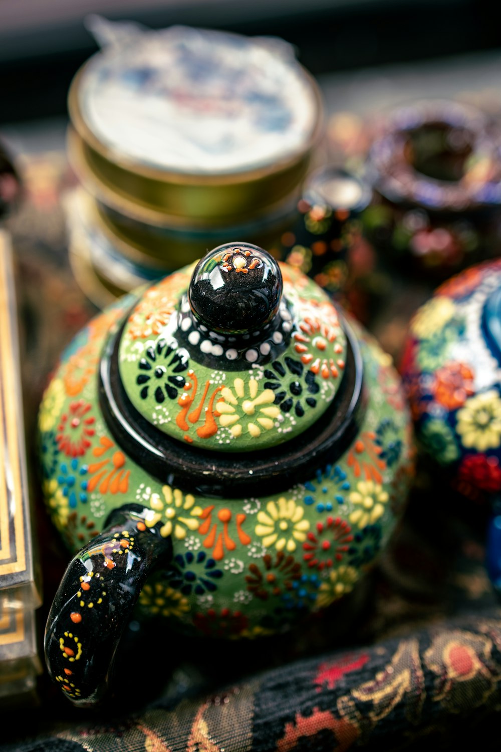 a colorful teapot sitting on top of a table