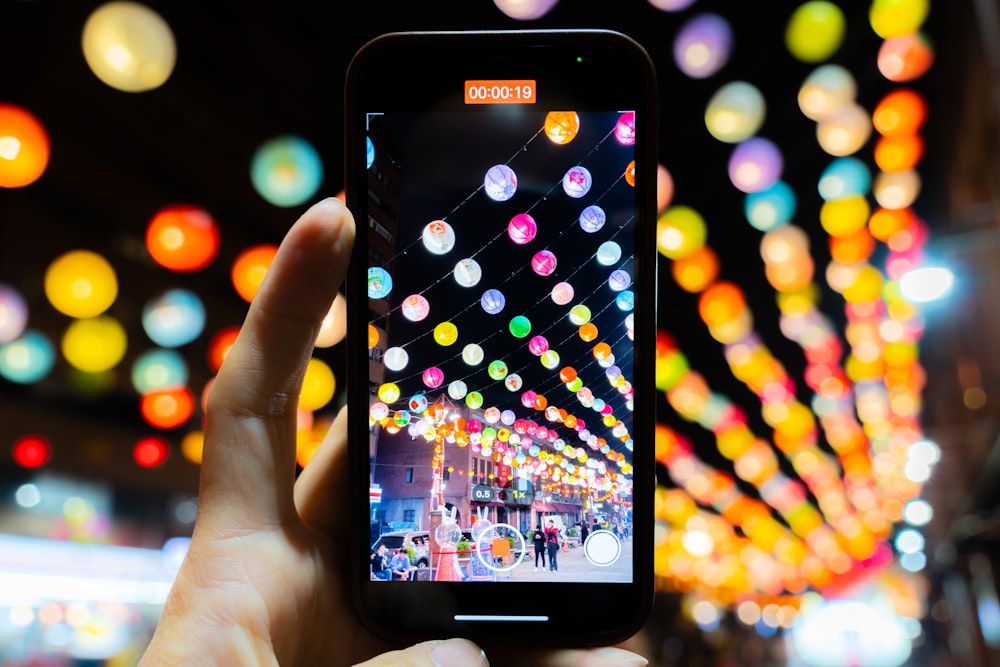 a person holding a cell phone in their hand